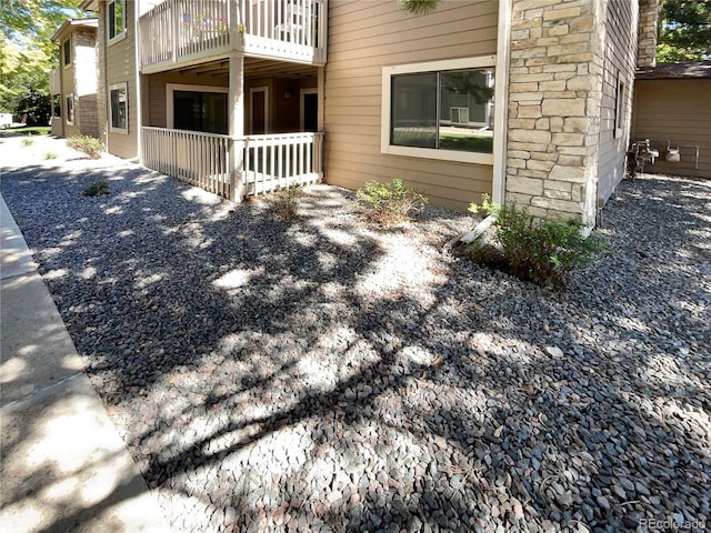 view of home's exterior with a balcony