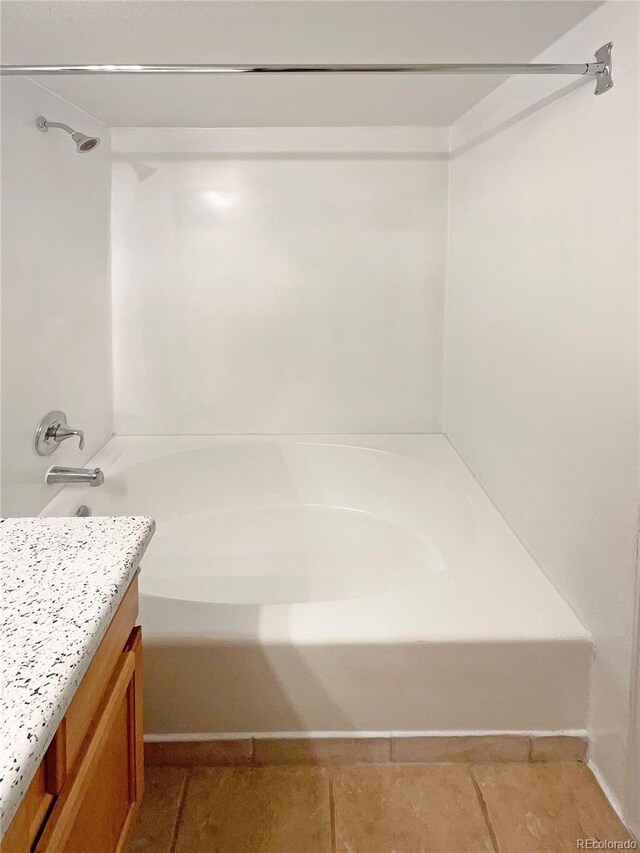 bathroom featuring tub / shower combination, vanity, and tile patterned flooring