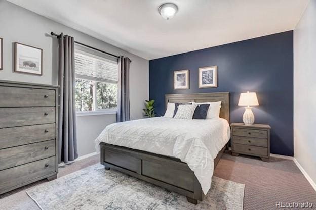 carpeted bedroom featuring baseboards