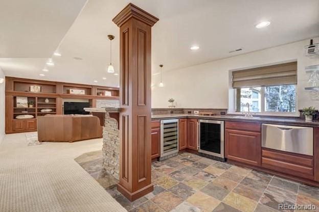 kitchen featuring beverage cooler, stainless steel dishwasher, recessed lighting, a sink, and brown cabinetry