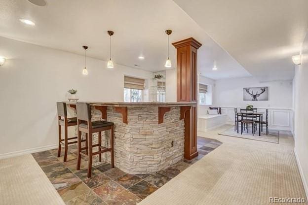 bar with pendant lighting and recessed lighting