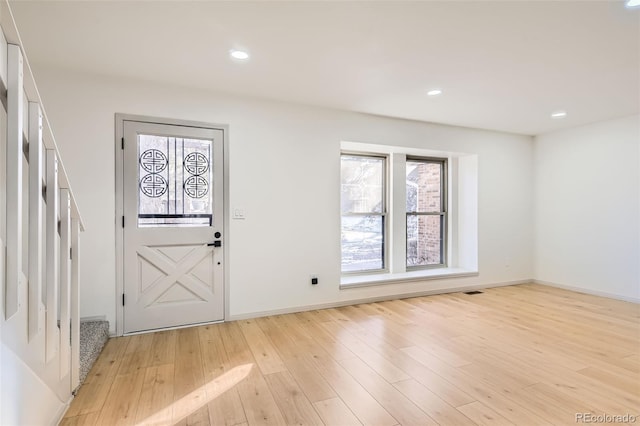 foyer entrance with light hardwood / wood-style floors