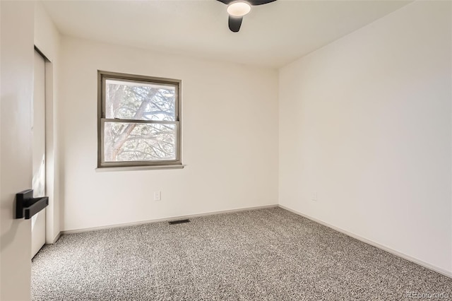 carpeted spare room featuring ceiling fan