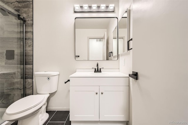 bathroom with toilet, tile patterned floors, walk in shower, and vanity