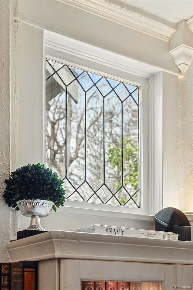 room details featuring ornamental molding and a textured wall