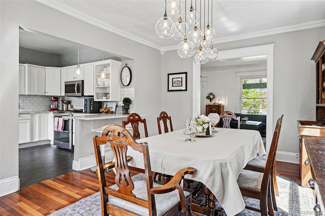 dining space with crown molding, baseboards, a notable chandelier, and dark wood-style floors