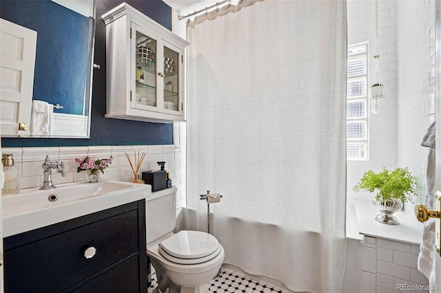 bathroom featuring tile walls, vanity, toilet, and shower / bath combination with curtain