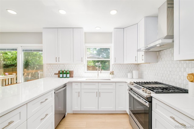16438 E Prentice Cir, Centennial, CO 80015 - kitchen with appliances with stainless steel finishes, wall chimney exhaust hood, healthy amount of natural light, light countertops, and recessed lighting