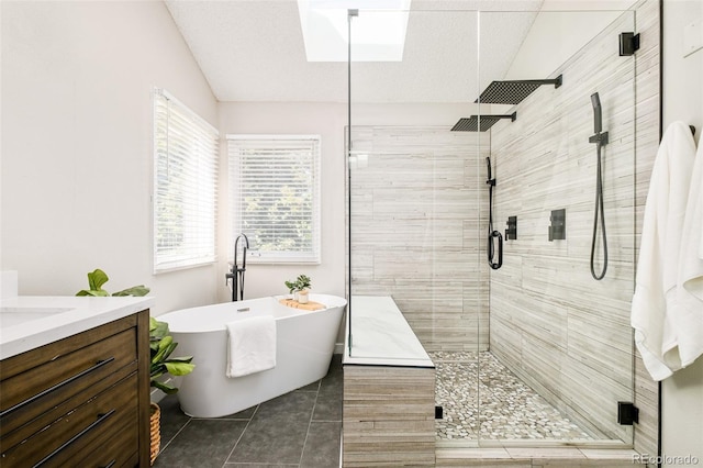 16438 E Prentice Cir, Centennial, CO 80015 - bathroom with a shower stall, a freestanding bath, vaulted ceiling, vanity, and tile patterned floors
