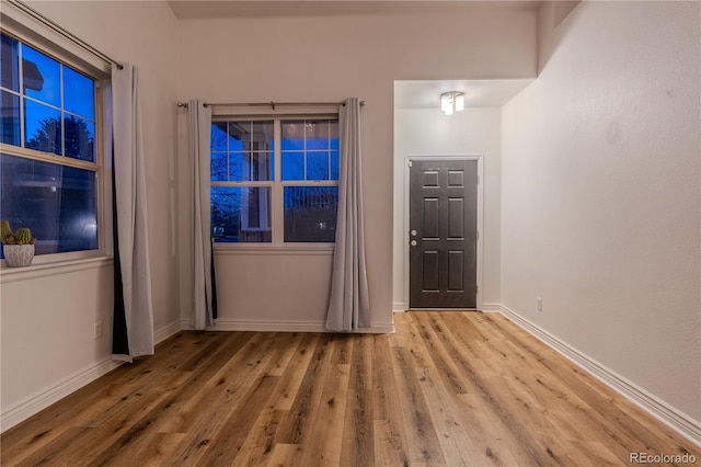 unfurnished room with light wood-type flooring