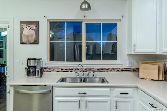 kitchen with dishwasher, tasteful backsplash, white cabinetry, and sink