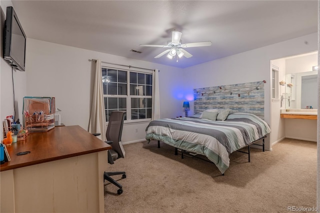 bedroom with connected bathroom, ceiling fan, and light colored carpet