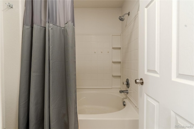 bathroom with shower / bath combo with shower curtain