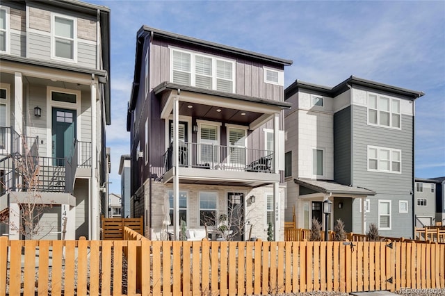 view of front of house featuring board and batten siding and a fenced front yard