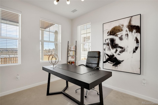 home office with light carpet, visible vents, and baseboards