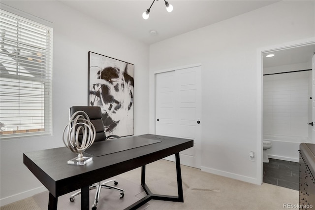 office with plenty of natural light, light colored carpet, and baseboards