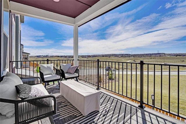 balcony with a rural view and an outdoor living space