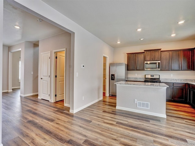 kitchen featuring stainless steel appliances, visible vents, and light wood finished floors