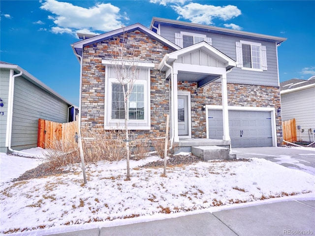 view of front of property with board and batten siding, an attached garage, fence, and stone siding