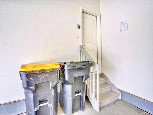 staircase with concrete floors