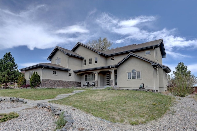 14993 W 55th Dr, Golden, CO 80403 - view of front facade featuring stucco siding and a front lawn