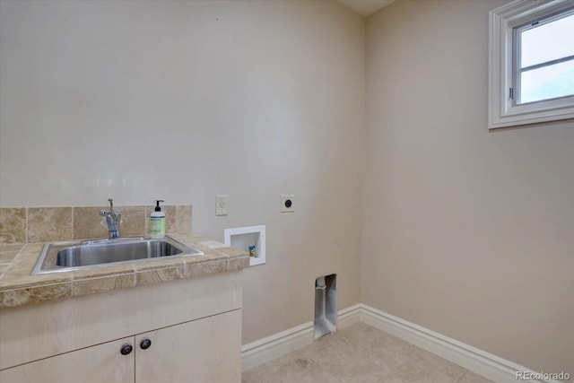 14993 W 55th Dr, Golden, CO 80403 - laundry room with electric dryer hookup, cabinet space, baseboards, washer hookup, and light tile patterned floors
