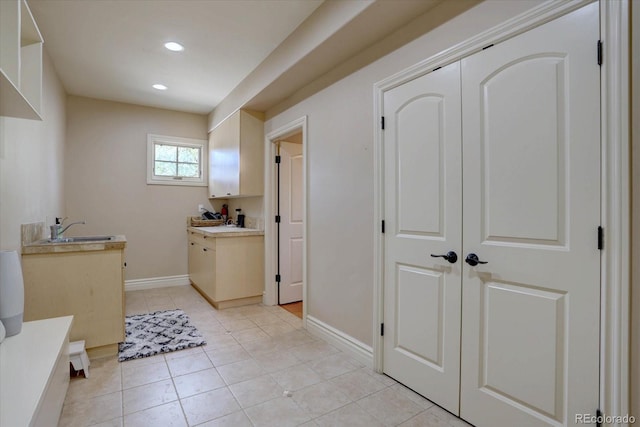 14993 W 55th Dr, Golden, CO 80403 - laundry area featuring a sink, recessed lighting, baseboards, and light tile patterned floors