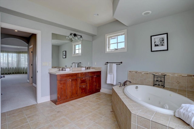 14993 W 55th Dr, Golden, CO 80403 - full bath featuring double vanity, a whirlpool tub, baseboards, and tile patterned flooring