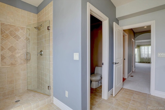14993 W 55th Dr, Golden, CO 80403 - bathroom with a shower stall, toilet, tile patterned flooring, and baseboards
