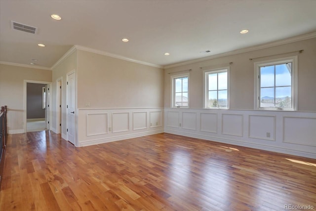 14993 W 55th Dr, Golden, CO 80403 - empty room featuring light wood-type flooring, recessed lighting, a decorative wall, and crown molding