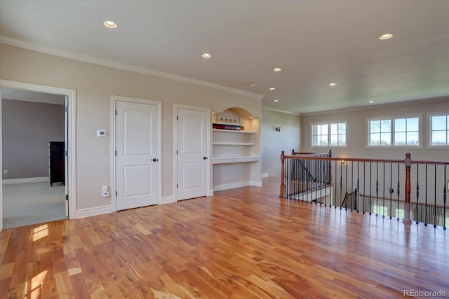 14993 W 55th Dr, Golden, CO 80403 - unfurnished room with ornamental molding, built in features, wood finished floors, recessed lighting, and baseboards