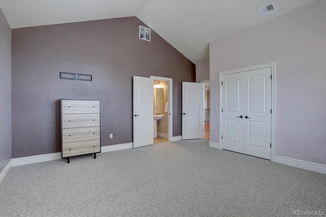 14993 W 55th Dr, Golden, CO 80403 - unfurnished bedroom with high vaulted ceiling, carpet floors, baseboards, connected bathroom, and a closet