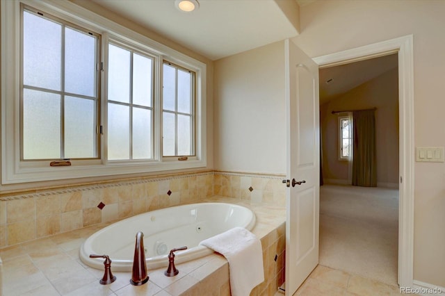 14993 W 55th Dr, Golden, CO 80403 - bathroom featuring a whirlpool tub, tile patterned floors, baseboards, and vaulted ceiling