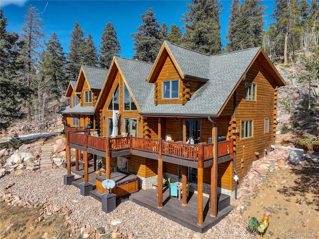 11450 Marks Dr, Conifer, CO 80433 - rear view of house featuring a jacuzzi, log exterior, roof with shingles, a wooden deck, and a patio