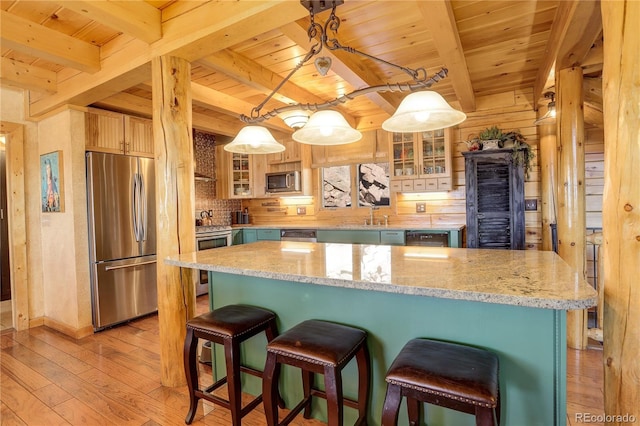 11450 Marks Dr, Conifer, CO 80433 - kitchen featuring appliances with stainless steel finishes, wood ceiling with exposed beams, light wood-style flooring, glass insert cabinets, and decorative backsplash