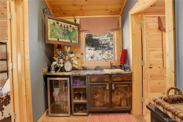 11450 Marks Dr, Conifer, CO 80433 - indoor dry bar featuring wine cooler, wooden ceiling, vaulted ceiling, and a textured wall