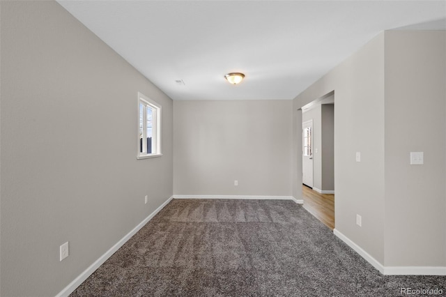 spare room with carpet floors and baseboards