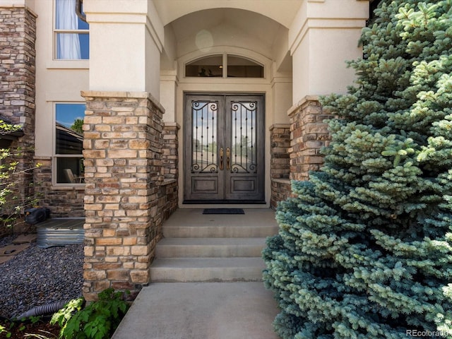 10057 S Shadow Hill Dr, Lone Tree, CO 80124 - property entrance featuring stucco siding, french doors, and stone siding