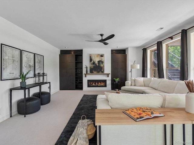 10057 S Shadow Hill Dr, Lone Tree, CO 80124 - living area featuring ceiling fan, carpet floors, a warm lit fireplace, and baseboards