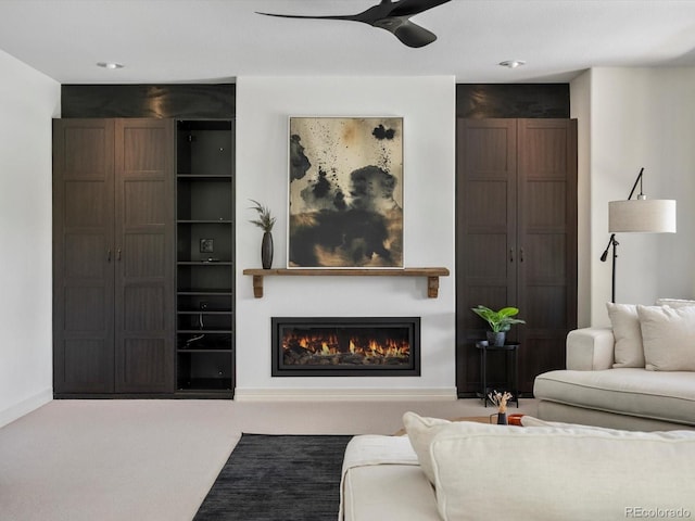 10057 S Shadow Hill Dr, Lone Tree, CO 80124 - carpeted living room with a lit fireplace, a ceiling fan, and baseboards