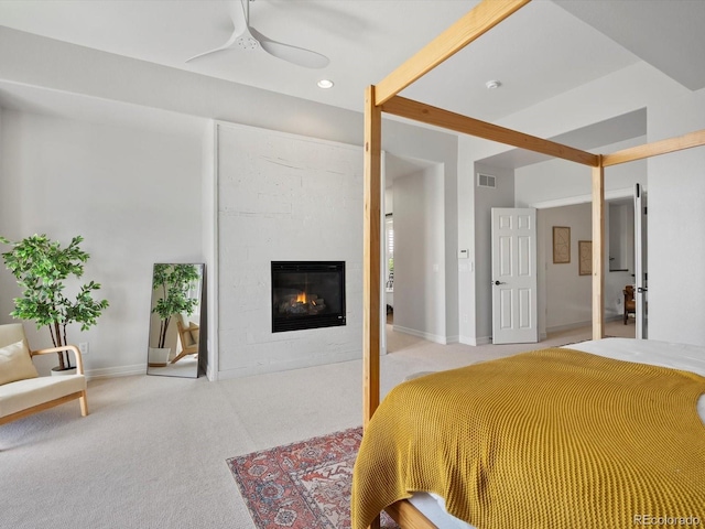 10057 S Shadow Hill Dr, Lone Tree, CO 80124 - bedroom with light colored carpet, a glass covered fireplace, recessed lighting, and baseboards