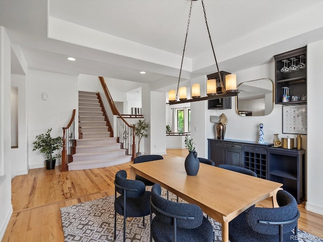 10057 S Shadow Hill Dr, Lone Tree, CO 80124 - dining room with a raised ceiling, stairs, light wood-style floors, recessed lighting, and baseboards