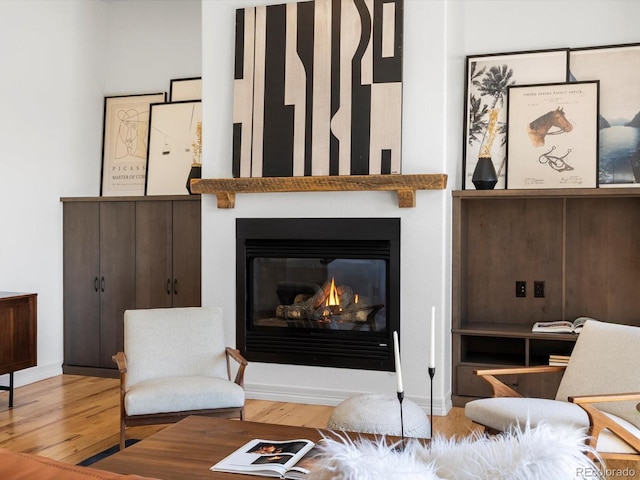 10057 S Shadow Hill Dr, Lone Tree, CO 80124 - living room featuring wood finished floors, a glass covered fireplace, and baseboards