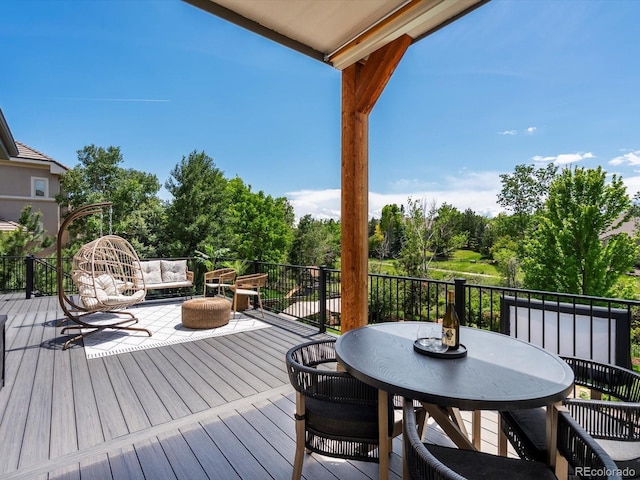 10057 S Shadow Hill Dr, Lone Tree, CO 80124 - wooden deck with outdoor dining area and view of wooded area