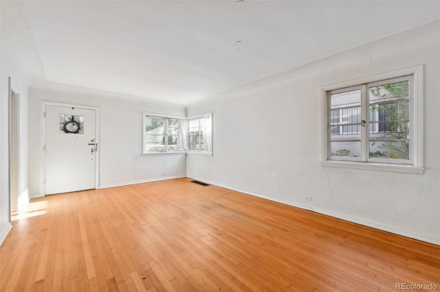 unfurnished room featuring light hardwood / wood-style flooring and a healthy amount of sunlight