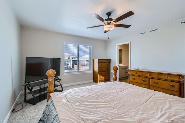 carpeted bedroom with connected bathroom and ceiling fan