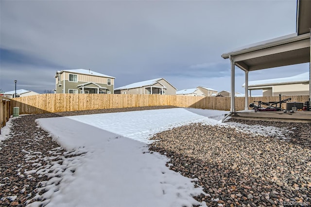 yard layered in snow featuring a patio