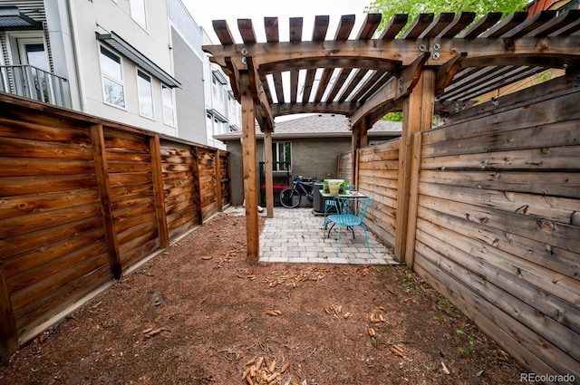 view of patio / terrace with a fenced backyard and a pergola