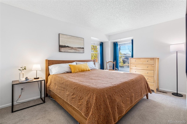 carpeted bedroom featuring a textured ceiling