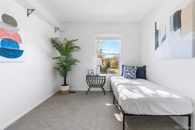 carpeted bedroom featuring a textured ceiling